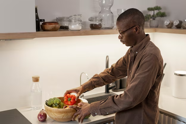 A guest cooking in a serviced apartment kitchen.